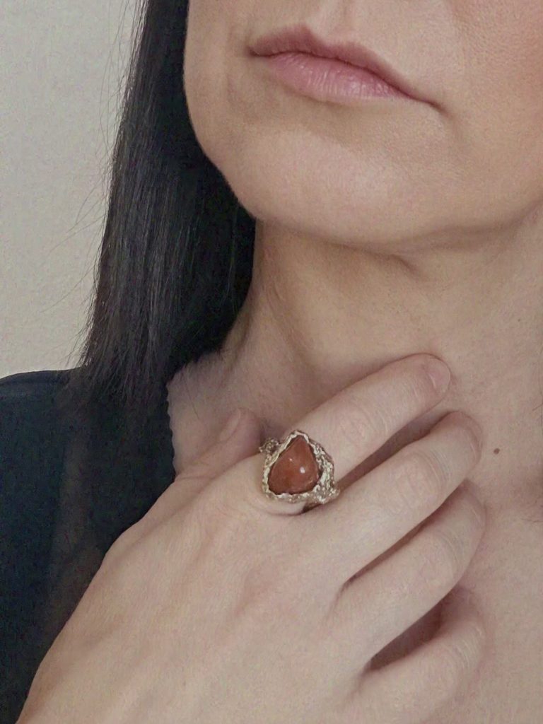 Hand wearing sculptural jewellery with organic asymmetrical form